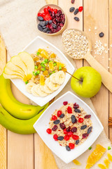 Healthy vegetarian (vegan) breakfast with oatmeal and fruits.