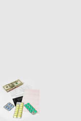 dollars, pills, cardiogram and medical a appointment on white background