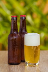 Brown beer bottles on a table on a green background