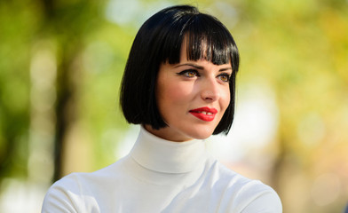 Fototapeta premium Makeup bright accent on lips. Red lipstick makeup suits her. Perfect makeup for brunette lady. Fashion and beauty concept. Woman mysterious with red lips makeup face defocused background close up