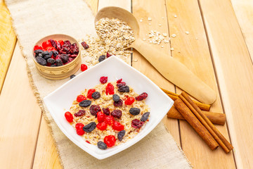 Healthy vegetarian (vegan) breakfast with oatmeal and fruits.