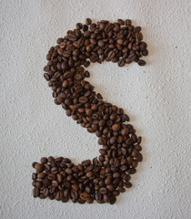 Image of roasted coffee beans shaped alphabet on a white background