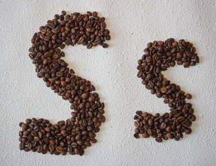 Image of roasted coffee beans shaped alphabet on a white background