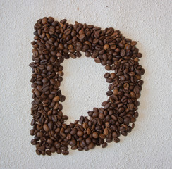 Image of roasted coffee beans shaped alphabet on a white background