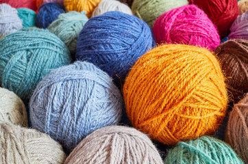 Colorful wool yarn balls, shallow depth of field.
