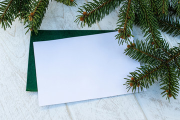 Green branches of a Christmas tree and cones on the background of white boards. Place for text.