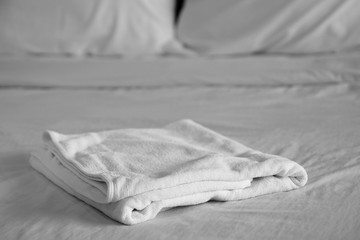 White towel on bed in bedroom