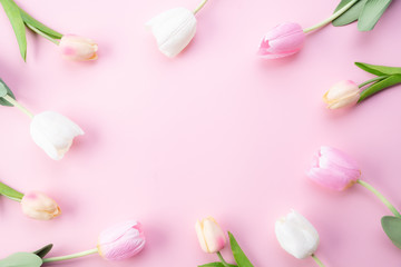 Happy mothers day concept. Top view of pink tulip flowers in frame on pink pastel background. Flat lay.