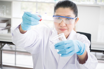 Asian scientist in the laboratory working at lab with test tubes concept