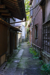 Fototapeta na wymiar Old vintage wooden Japanese house and near river.The old brick street wtih old town area, Traditional japanese wood facade in a typical house of Japan.