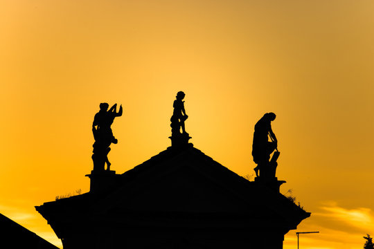 italian sculptures in sunset, ancient statues on a famous building in friuli-venezia giulia
