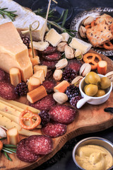 Appetizer Board. Cheese plate with cheeses, crackers, veggies, nuts, variety of meat and toppings. 