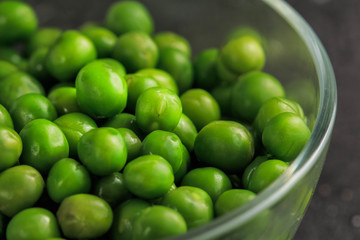 Buttered Peas. Green Peas on dark background.