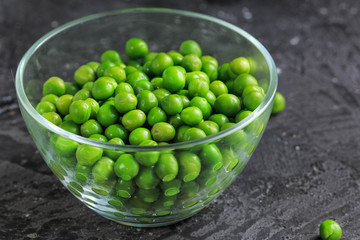 Buttered Peas. Green Peas on dark background.