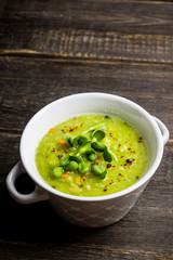 Hot green peas soup on the rustic background. Selective focus. Shallow depth of field.