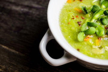 Hot green peas soup on the rustic background. Selective focus. Shallow depth of field.