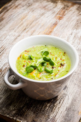 Hot green peas soup on the rustic background. Selective focus. Shallow depth of field.