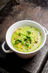 Hot green peas soup on the rustic background. Selective focus. Shallow depth of field.