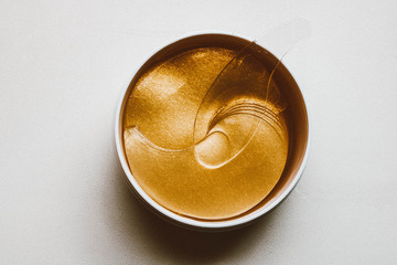 Set of eye patches. Golden eye patches in the plastic jar.