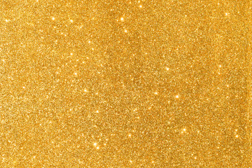 sparkles of golden glitter abstract background