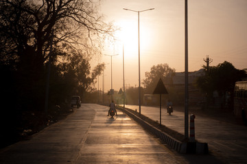 Motor Scooter on empty street at sunset, toxic air, pollution