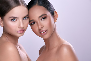 beauty portrait of two girls with naked shoulders