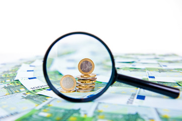 Euro with a  magnifying glass