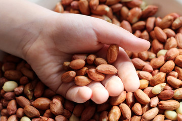 Ground peanuts in children's hands