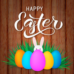 Happy Easter calligraphy lettering. Colorful easter eggs and bunny on wood background.  Easy to edit vector template for spring holidays  party invitation, typography poster, greeting card, banner.