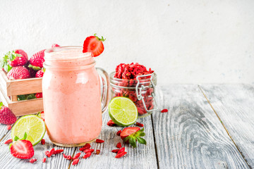Healthy blended drink. Organic diet smoothie with lime, strawberry and goji berries, wooden...