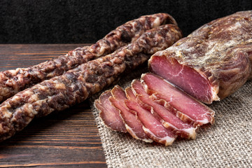 Dried pork meat on dark wooden background