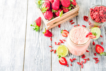 Healthy blended drink. Organic diet smoothie with lime, strawberry and goji berries, wooden...