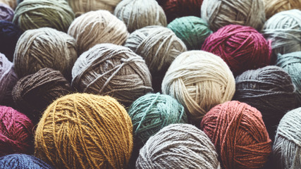 Vintage toned picture of wool yarn balls, shallow depth of field. - obrazy, fototapety, plakaty