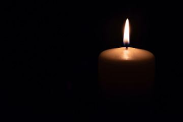 Fototapeta na wymiar the candle burns on a black background