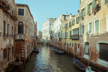 Fototapeta na wymiar Сhannel with boats in Venice, Italy. Beautiful romantic italian city.