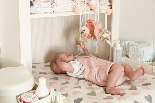 Baby Girl Lying On The Changing Table