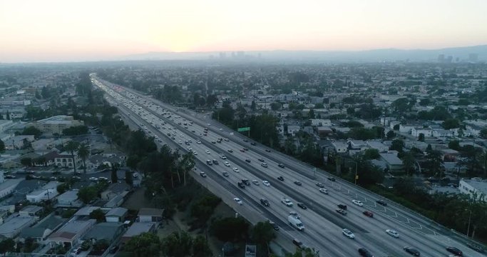 Sunset Aerial View of Santa Monica Freeway at rush hour by Airflow Creations. Los angeles, slow motion, long shot, crane shot, aerial shot, high angle, natural lighting, la, california, 