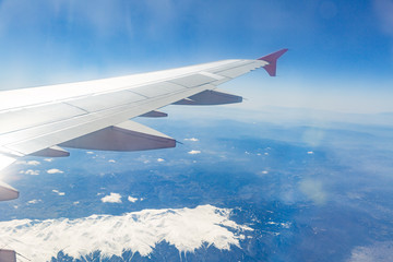 Obraz premium view from the window of the plane that flies over the mountains