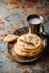 Chocolate chip cookies on old rusty blue table. American cuisine. Copy space.