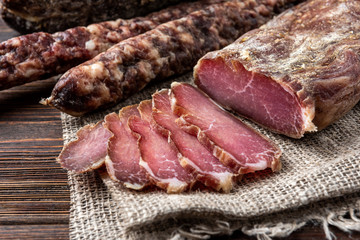 Dried pork meat on dark wooden background