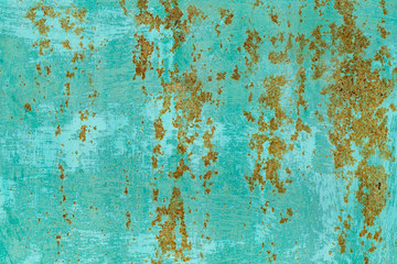 Closeup flatlay texture of old rusty metal painted in green bright color. Horizontal abstract photography.