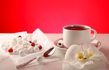 Cranberries in powdered sugar, with a cup of strong black tea.