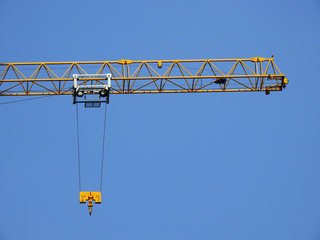 yellow crane and blue sky on building site