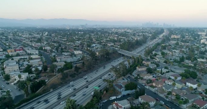 New Freeway Aerial of Downtown Los Angeles alongside the Santa Monica Freeway I-10 in California. Los Angeles, Airflow Creations, Drone, Dusk, Cars, slow motion, long, crane, aerial 