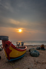 Obraz premium Fishermen boat on shore sunrise view