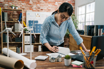 Concept architects engineer holding pen writing on notebook. beautiful asian female office worker...