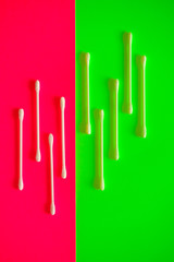 Cotton swab on a pink background.