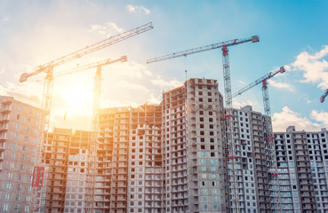View large-scale construction of a residential complex with a view of construction cranes.