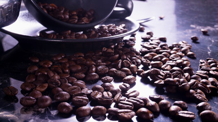 Coffee beans in coffee cup on black marble table