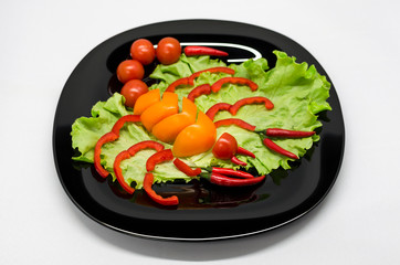vegetables on a plate laid out in the shape of a scorpion	